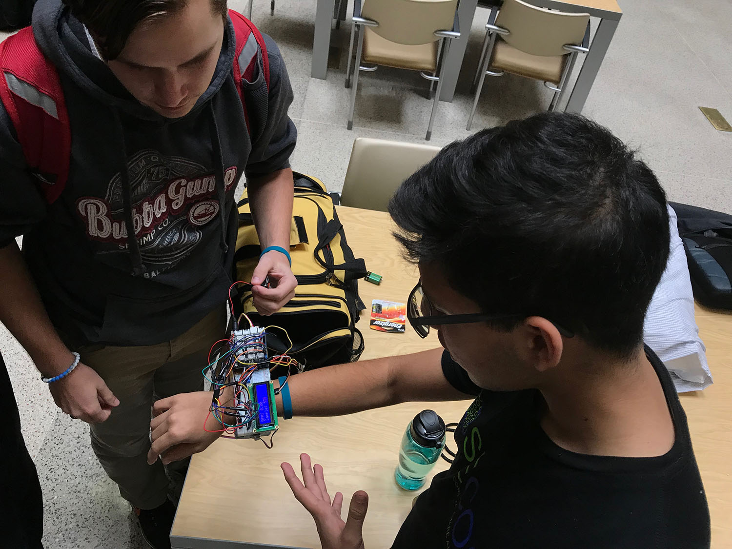 Group working on a watch-type device to measure vital signs